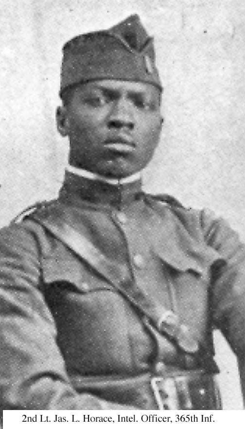 Publication portrait of an officer in a garrison cap, cropped at the waist.