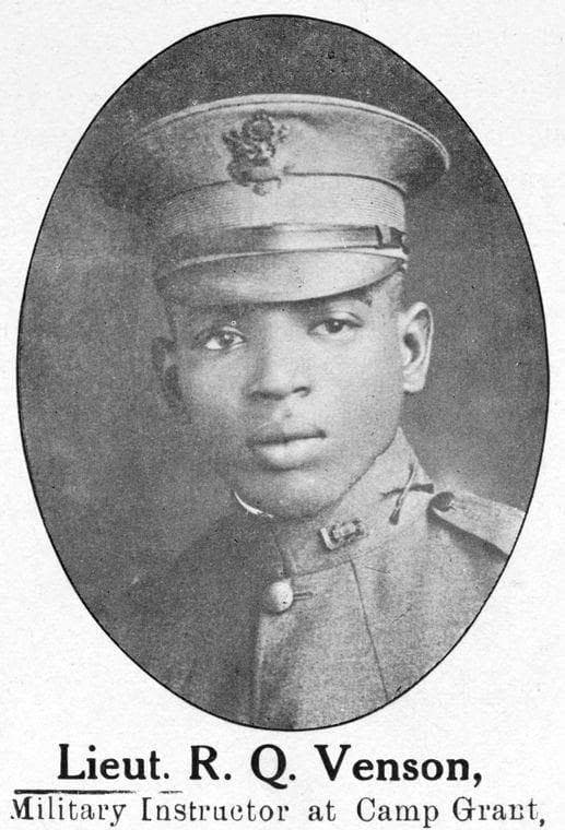 Oval-framed publication portrait of a young officer in a peaked service cap.